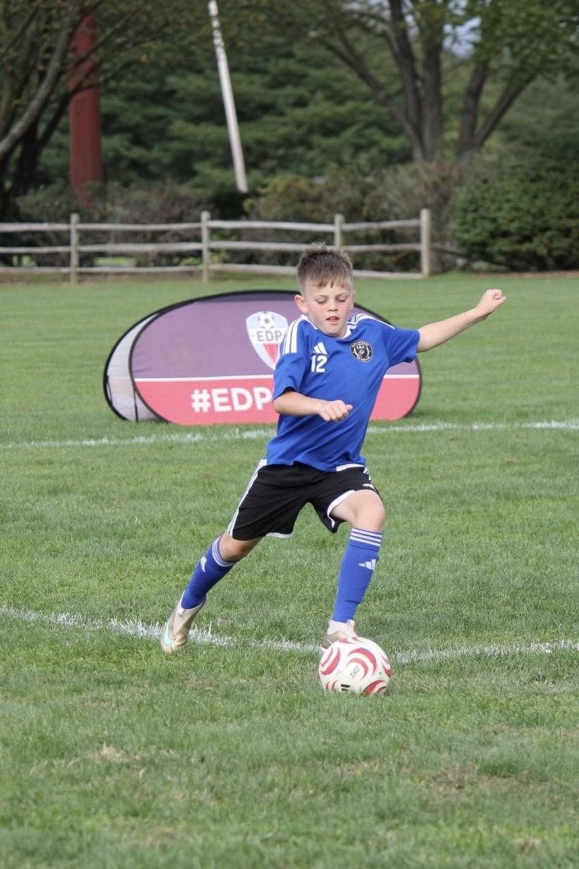 EKS U11 player striking the ball