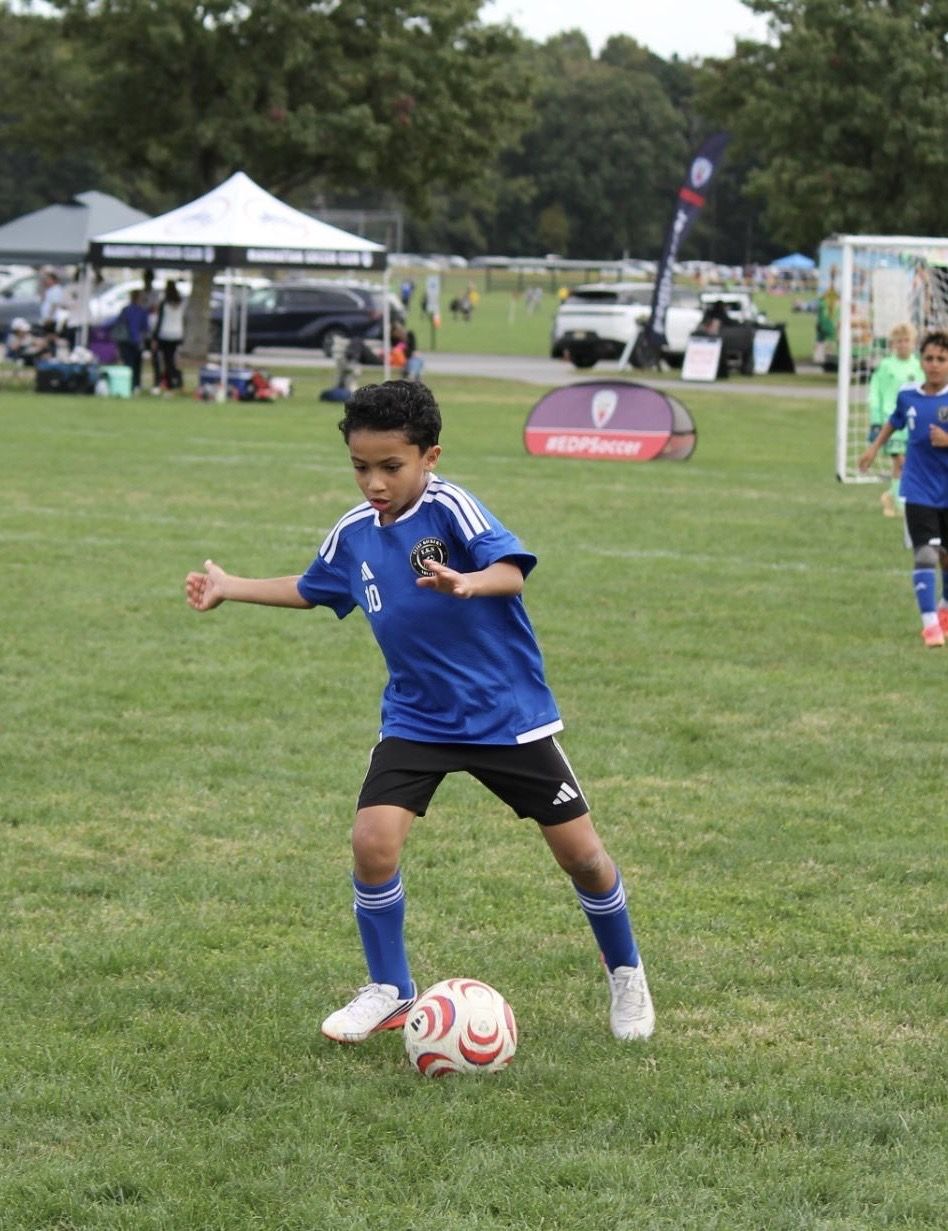 EKS U11 player dribbling at an EDP game
